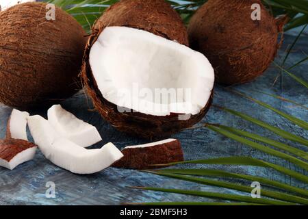 Fresh raw coconut with palm leaves on background. Ripe coconut fruits Stock Photo