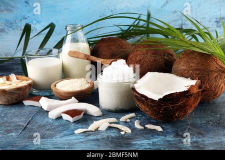 Coconut products with fresh coconut, Coconut flakes, spa oil. Ripe coconut fruits Stock Photo