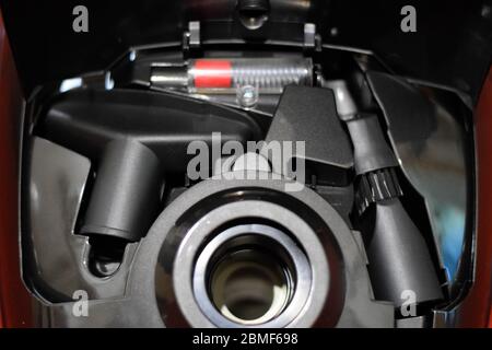 A vacuum cleaner with a set of brushes and bags. A vacuum cleaner on the red carpet. Stock Photo