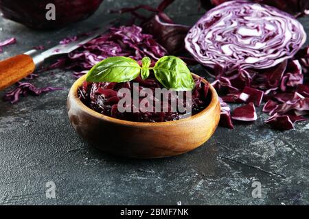 pickled red cabbage and Chopped fresh red cabbage. Prepare sliced vegetable for cooking purple cabbage salad or coleslaw. Homemade fresh food concept. Stock Photo