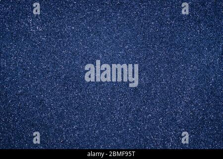 Abstract grain background, dark blue granular texture. Grunge wall shiny surface. Pantone color trend Stock Photo