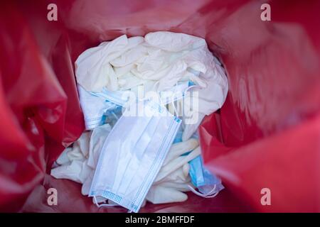 Inside view of waste bin with discarded gloves and mask Stock Photo