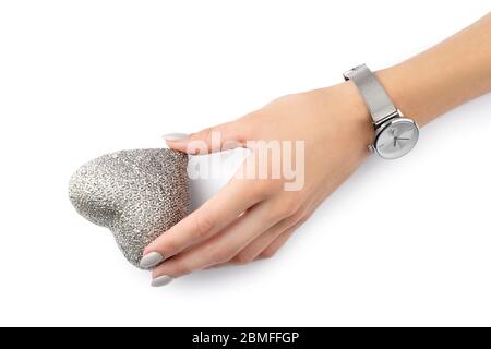 Beautiful womans hand with manicure holding heart isolated on white Stock Photo