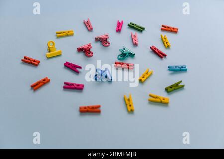 Pegs and clips against colorful background Stock Photo
