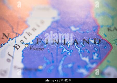 Shallow depth of field focus on geographical map location of country Finland in Europe continent on atlas Stock Photo