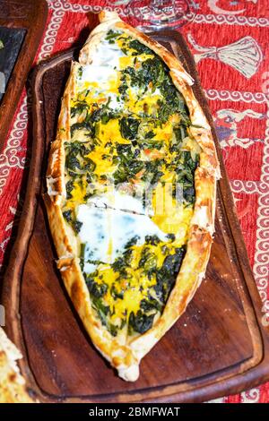 Traditional autyhentic turkish lunch or dinner: kebab with rice and vegetables, spinach and egg pide, pita flat bread and puff hot lavash or lavas hom Stock Photo