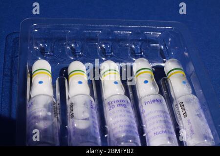 Viersen, Germany - May 8. 2020: Close up of isolated plastic blister with Triam cortisone 20 mg vials, blue background (focus on center) Stock Photo
