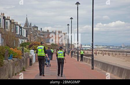 Portobello Beach Edinburgh, Scotland, UK, 9th May 2020. Early Police appearance of four officers both male and female at the reasonably quiet seaside today perhaps in expectation of the warmer weather bringing more visitors to take their permitted excercise. Stock Photo