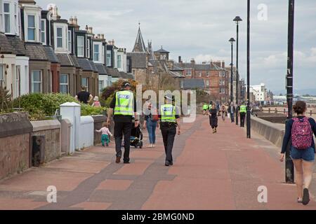 Portobello Beach Edinburgh, Scotland, UK, 9th May 2020. Early Police appearance of four officers both male and female at the reasonably quiet seaside today perhaps in expectation of the warmer weather bringing more visitors to take their permitted excercise. Stock Photo