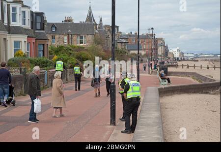 Portobello Beach Edinburgh, Scotland, UK, 9th May 2020. Early Police appearance of four officers both male and female at the reasonably quiet seaside today perhaps in expectation of the warmer weather bringing more visitors to take their permitted excercise. Stock Photo