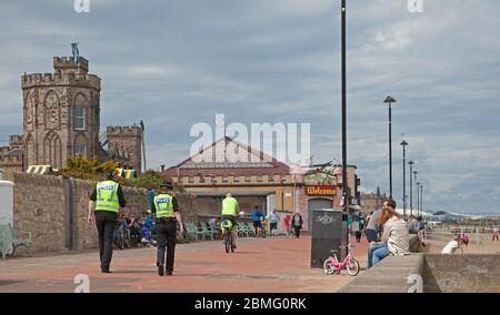 Portobello Beach Edinburgh, Scotland, UK, 9th May 2020. Early Police appearance of four officers both male and female at the reasonably quiet seaside today perhaps in expectation of the warmer weather bringing more visitors to take their permitted excercise. Stock Photo