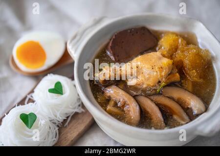 Braised Fish Maw in Red Gravy soup with chicken,  bamboo shoot and Shiitake mushrooms Stock Photo