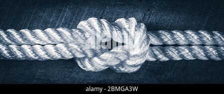 Close-up Of White Rope Linked Together On Wooden Ship Deck - Strength In Partnership Concept Stock Photo