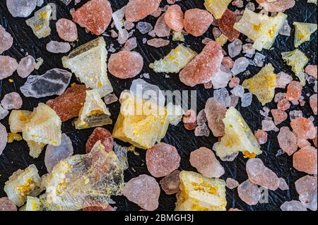 Close-up of himalayan and yellow lemon-flavored salt crystals over a slate board Stock Photo