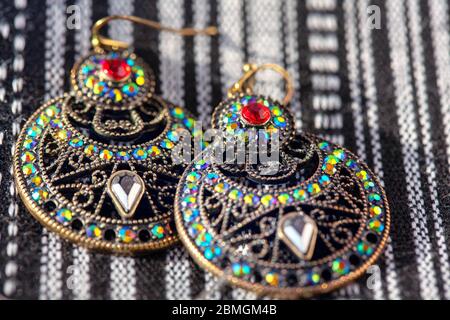 earrings inlaid with colored stones in oriental style Stock Photo