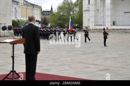 Moscow, Russia. 09th May, 2020. Russian President Vladimir Putin reviews the Presidential Regiment honor guard during the 75th anniversary of the victory over Nazi Germany in World War Two, in Sobornaya Square at the Kremlin walls May 9, 2020 in Moscow, Russia. The annual Victory Day military parade and rally was cancelled because of the coronavirus pandemic. Credit: Alexei Druzhinin/Kremlin Pool/Alamy Live News Stock Photo