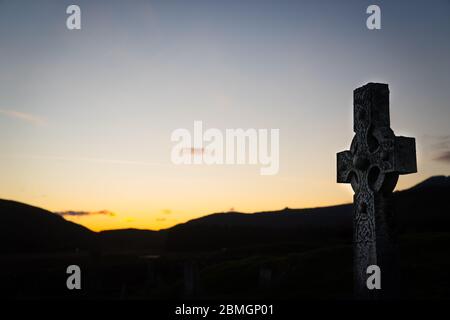 A celtic cross headstone in the graveyard of the abandoned Cill Chriosd church near Boradford, on the Isle of Skye.  Taken near sunset. Stock Photo