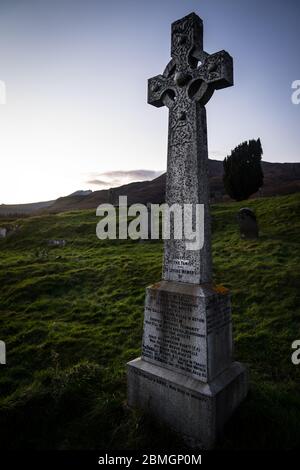 A celtic cross headstone in the graveyard of the abandoned Cill Chriosd church near Boradford, on the Isle of Skye.  Taken near sunset. Stock Photo