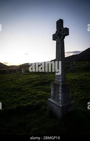 A celtic cross headstone in the graveyard of the abandoned Cill Chriosd church near Boradford, on the Isle of Skye.  Taken near sunset. Stock Photo