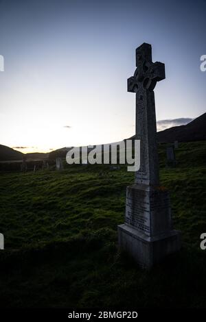 A celtic cross headstone in the graveyard of the abandoned Cill Chriosd church near Boradford, on the Isle of Skye.  Taken near sunset. Stock Photo