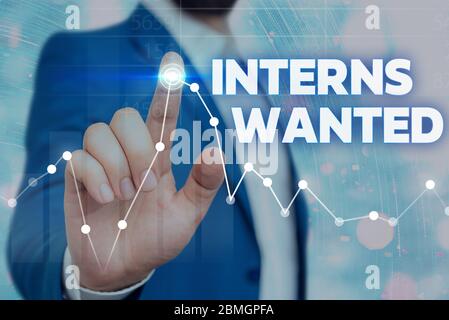 Writing note showing Interns Wanted. Business concept for Looking for on the job trainee Part time Working student Stock Photo