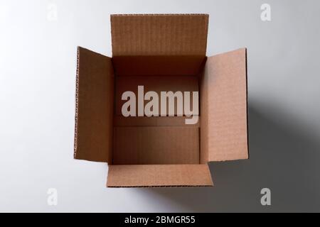 Open empty rectangular cardboard box on grey background. Mockup for design and advertising. Brown craft paper or carton box mock up. Top view Stock Photo