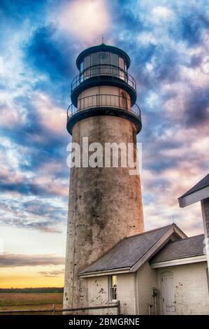 The highland lighthouse in north truro massachusetts on cape cod against a dramatic sunset sky built in 1857. Stock Photo