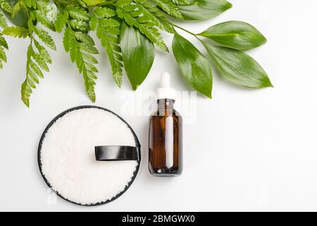 Organic bio cosmetics with herbal ingredients. Natural extract, oil, serum with fresh leaves. Flat lay, handmade beauty and spa, perfume or cream Stock Photo