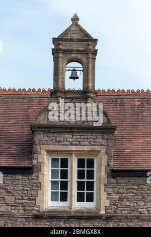 Bristol-May-2020-England- a close up view of a bell above a small church window Stock Photo