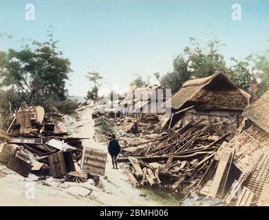 [ 1890s Japan - Nobi Earthquake Destruction ] —   Devastation in Ichinomiya (一の宮村) in Aichi Prefecture caused by the Nobi Earthquake (濃尾地震, Nobi Jishin) of October 28, 1891 (Meiji 24).  Debris is piled up along a cracked road. The Nobi Earthquake measured between 8.0 and 8.4 on the scale of Richter and caused 7,273 deaths, 17,175 casualties and the destruction of 142,177 homes.  It is the largest recorded quake in inland Japan. It jumpstarted the study of seismology in Japan and proved that earthquakes are caused by fault lines.  19th century vintage albumen photograph. Stock Photo