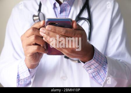 Close up of doctor hand using smartphone in the hospital. Stock Photo