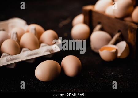 Fresh organic chicken eggs from the farm on dark grunge background Stock Photo