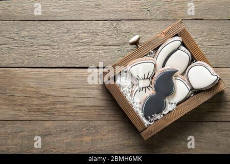Happy father's day concept. Tasty cookies in a box on a wooden background. Place for text Stock Photo