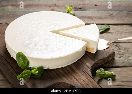 Tasty homemade cheesecake on a wooden background. Place for text.