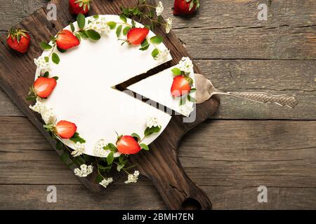 Tasty cheesecake with strawberries on a wooden background. Beautiful composition Stock Photo