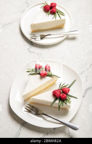 A slice of cheesecake with raspberries on a plate. Close-up. Stock Photo