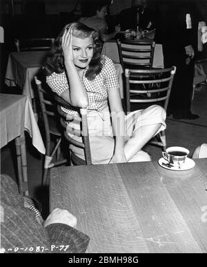 RITA HAYWORTH on set candid during filming of GILDA 1946 director CHARLES VIDOR gowns JEAN LOUIS producer VIRGINIA VAN UPP Columbia Pictures Corporation Stock Photo