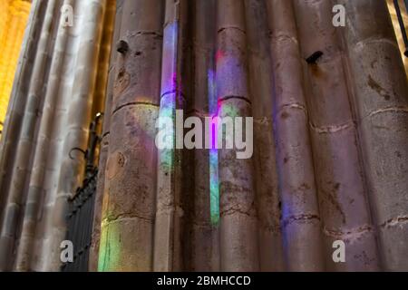 Rainbow reflection on stone column (Santa Eulalia and the Holy Cross cathedral or Barcelona cathedral) Stock Photo