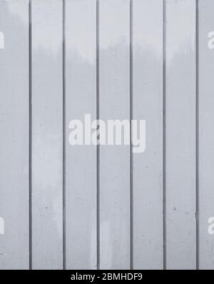 Close-up of a concrete wall painted in gray with lighter stains or smudges. Abstract high resolution full frame textured background. Stock Photo