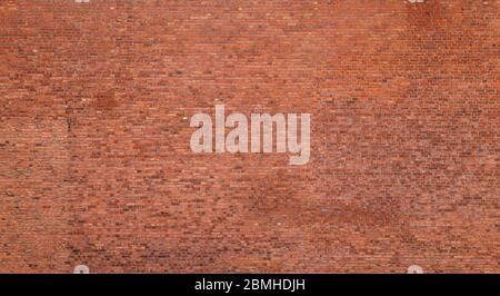 Big old red brick wall. Full frame textured background of detailed old and weathered brick wall. Stock Photo