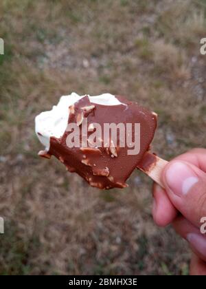 Eskimo ice cream with chocolate on a stick. Bitten ice cream. Stock Photo