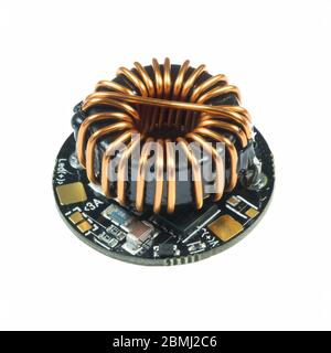 Black round led driver PCB board with inductance coil and surface mount components in a close-up view Stock Photo