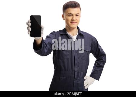 Young mechanic holding a mobile phone isolated on white background Stock Photo