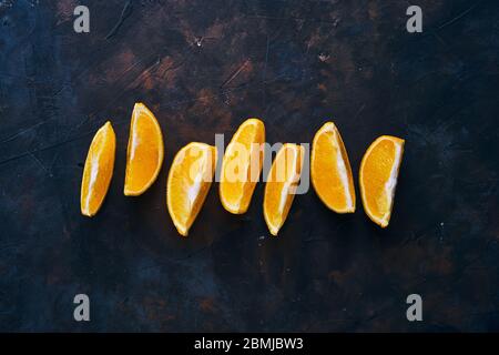 Seven Orange slices on a dark background.  Stock Photo