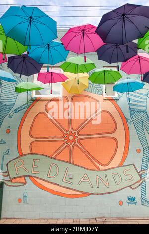 Wall mural on Orange Street Alley in Redlands, CA for below hanging umbrellas Stock Photo
