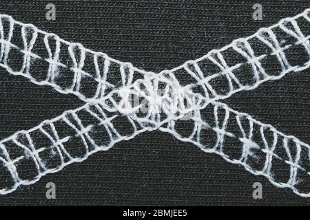 White seams on black fabric. stitches on textile material close up Stock Photo