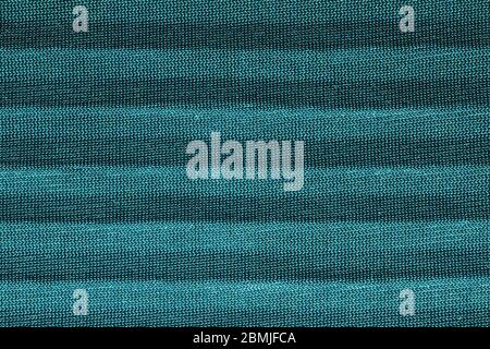 Green textured cotton fabric. Ribbed texture. Solid seamless
