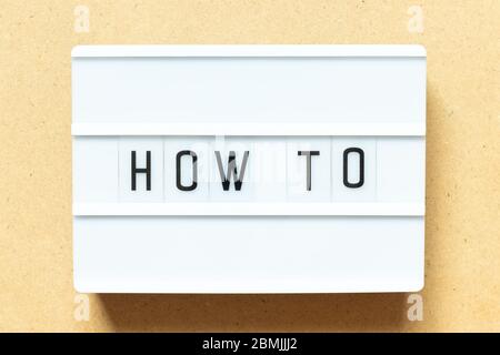 Lightbox with word how to on wood background Stock Photo