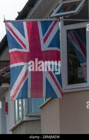 Bristol-May-2020-England- a close up view of a england flag hanging outside a window on the bank holiday for the seventy  four years celebration of th Stock Photo