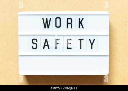 Lightbox with word work safety on wood background Stock Photo